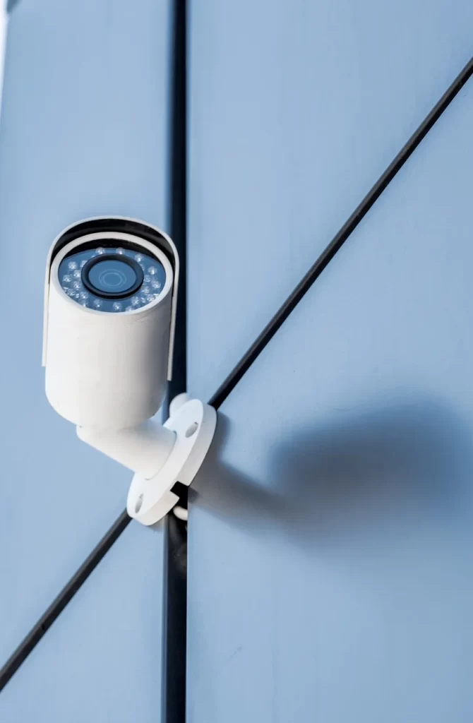 one-security-camera-on-blue-wall-of-office-building-security-system-concept.webp